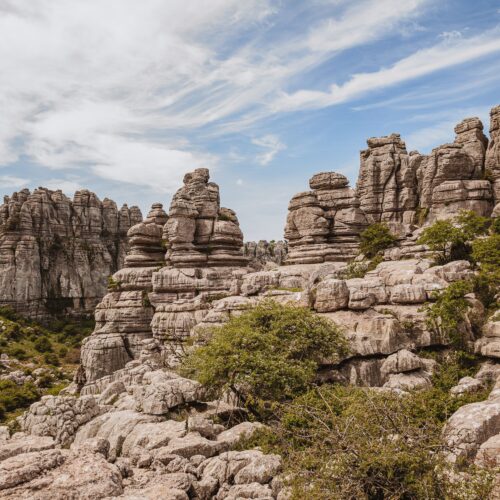 Formaciones rocosas calizas del Torcal de Antequera con vegetación dispersa y cielo azul