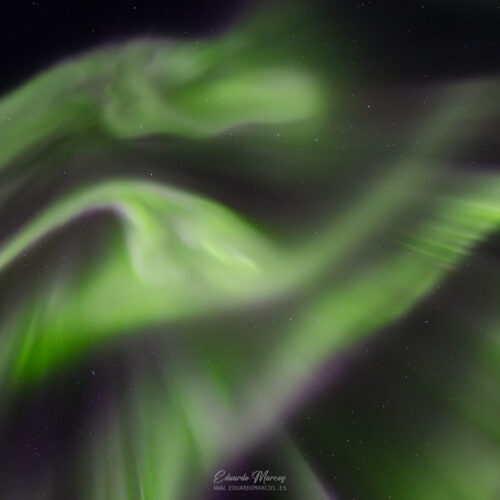 Luces verdes borrosas de aurora boreal contra cielo nocturno estrellado en Abisko